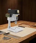 Compact 340W Mini Benchtop Drill Press on a wooden table, featuring a pure copper motor for precision DIY crafts.