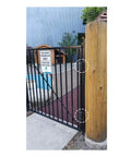 Heavy Duty Self Closing Pool And Child Safety Gate Hinges With Alignment Legs For Metal Gates chrome hinges mounted on a black safety gate.