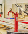 Top Shelf Heavy Duty Lever Drum Pump For Smooth Oil And Fuel Transfer with red frame on 55-gallon drum in background.