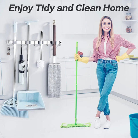 Person in kitchen holding mop with cleaning tools wall mount rack nearby, text 'Enjoy Tidy and Clean Home' above.