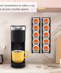 Side Mount K Cup Holder For Keurig Adhesive Metal Pod Organizer Matte Black Finish 2 Pack Keeps 10 K Cups Handy And Neat Space Saving Counter Mount For Keurig Coffee Makers. Displayed on a kitchen wall.