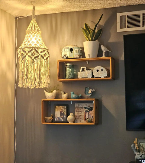 Boho Macrame Pendant Light With Plug In Cord And On Off Switch illuminating a cozy room corner with shelves and decor items.