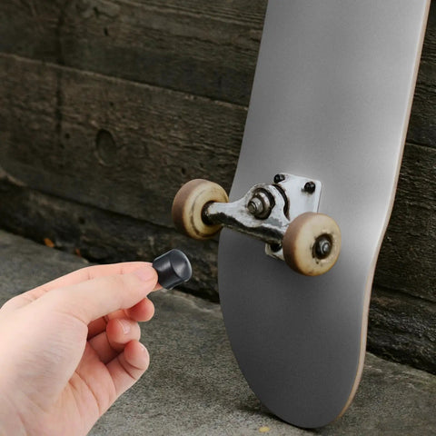 Hand holding pivot cup near longboard truck, 8 Pack Longboard Truck Pivot Cups Replacement For Most Longboards 18mm And 16mm With Deck Guards Protector And Hardware Set For A Smooth Ride And Built To Last.