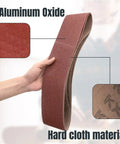 Person holding heavy duty sanding belt showing aluminum oxide texture for benchtop belt and disc sander 4 by 36 inches woodworking.