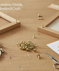 Gold Self Tapping Wood Screws With Integrated Washers on wood surface with DIY tools and picture frames in background.