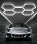 Hexagon LED Garage Lights 6500K Cool White Hex Ceiling Fixture For Garage, highlighting ceiling and sports car below.