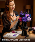 Woman assembling Purple Rose Bouquet Building Kit For Adults And Women, Lifelike 12 Piece Floral Set in black vase