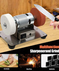 Slick Little Mini Belt Sander And Bench Grinder With 96 Watt Copper Motor For Smooth Knife And Tool Sharpening Adjustable Speed Home Wood And Metal Workshop Knockout Gem with a knife and motor.