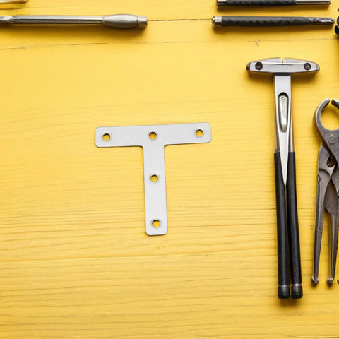 Beefy Heavy Duty Stainless Steel Corner Bracket Plates with tools on yellow surface, T shaped for metal and wood panels