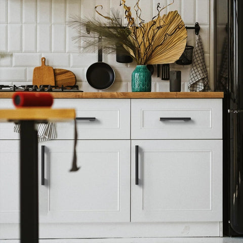Five Inch Black And Gold Knurled Cabinet Pulls Set Of Ten Heavy Duty Drawer Handles installed on white kitchen cupboards