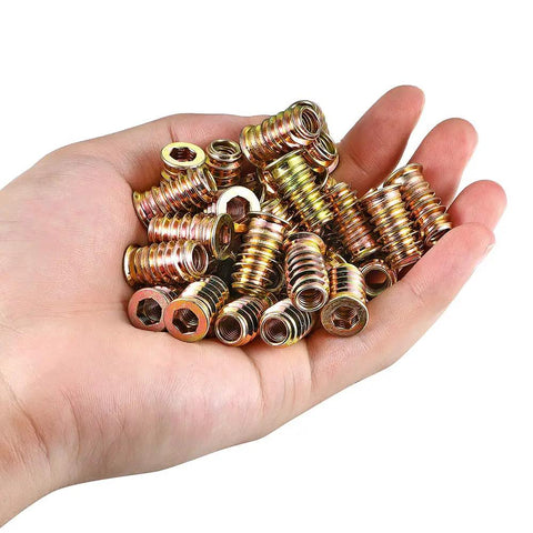 Hand holding One Quarter Inch Twenty Threaded Wood Inserts Kit For Furniture Repair 80 Piece Bundle Includes Drill Bit And Hex Wrench PGMJ Durable Steel Nut Inserts For Wood To Create Strong Bolt Fasteners