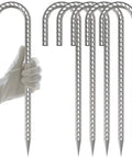 Gloved hand holding Tough As Nails Heavy Duty 12 Inch J Hook Rebar Stakes, 6 Pack, 5/16 Inch Galvanized Ground Anchors