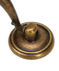 Base of vintage drop bail drawer pull handle in antique bronze finish, zinc alloy material for cabinets and desks, close-up view.