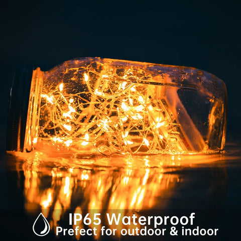 Glass jar with 12 Pack Fairy Lights Battery Operated String Lights 7 Feet Long With 20 Mini LEDs Waterproof Silver Wire glowing.