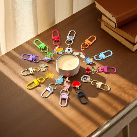 Super Vibrant Sixty Piece Zinc Alloy Keychain Clips With Swivel Lobster Claw Clasps arranged around a candle on a table.