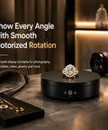 Motorized Rotating Display Stand 7.87 Inch Electric Spinning Turntable With Silent Operation, showcasing jewelry on a sleek black surface.
