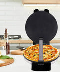 Heavy Duty Electric Tortilla Press 10 Inch Non Stick Roti Maker With Adjustable Heat Control cooking pizza on kitchen countertop.