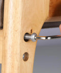 Built Like A Tank M6 X 12Mm Button Head Socket Cap Screws 100 Pack being tightened on wooden furniture with an Allen wrench.
