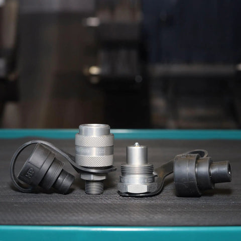 Heavy-Duty Three Eighths Inch Hydraulic Quick Connect Coupler Set For Ten Thousand PSI Systems, Three Eighths Inch NPT Thread, Screw-To-Connect, Steel With Zinc-Plated Finish For Corrosion Resistance And Secure Engagement On Pumps And Cylinders, shown with dust caps