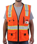 Heavy Duty Ansi Reflective Safety Vest In Bright Orange Mesh With Multi Function Pockets And 3M Retroreflective Tape worn by a model.