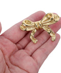 Top Shelf Vintage Bowknot Cabinet Knobs And Metal Drawer Pulls For Furniture Hardware decorative gold bowknot knob held in hand.