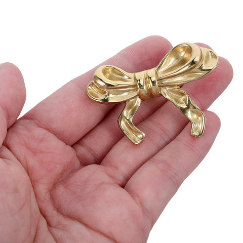 Top Shelf Vintage Bowknot Cabinet Knobs And Metal Drawer Pulls For Furniture Hardware decorative gold bowknot knob held in hand.