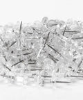 Legit Durable Push Pins 600 Count Standard Thumb Tacks With Kickass Steel Points And Clear Rounded Tops in a pile.