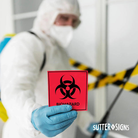 Heavy Duty Biohazard Stickers And Warning Decals Built Tough For Labs And Hospitals Includes Straight Up Essential Durable Vinyl Labels In A Solid Pack Of Ten For Zero Hassle Safety. Lab worker holding red biohazard warning decal.