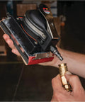 Top Shelf Pneumatic Orbital Sander With Built In Air Regulator And Rubber Over Mold Grip in hand connecting air hose.