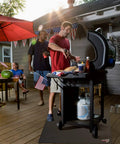 Man grilling on a deck with 40 Inch Square Fire Pit Mat For Decks, Patios And Grills, Fireproof And Waterproof Under Grill Pad