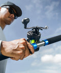 Angler using Chaos Pro Baitcasting Fishing Reel With CNC Machined Aluminum Unibody 25Lb Max Drag Level Wind Magnetic Braking outdoors