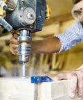 Drill Press Return Spring Set For Quill Coil Assembly, shown in use on bench drill, cutting through wood in workshop.
