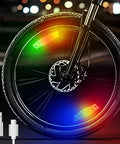 Rechargeable Bike Wheel Lights Set of 2 with Motion Sensor Weatherproof Spoke Lights illuminated on bike wheel at night with USB cord