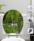 Round Graceful Swans Serene Willow Tree Reflected Calm Pond Toilet Seat on white toilet, showcasing resilient resin design.