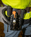 Electrician wearing Leather Tool Pouch With Four Pockets And Knife Holder, riveted belt mount shown, tools visible, durable handcrafted leather.