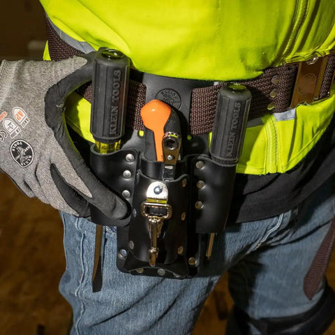 Electrician wearing Leather Tool Pouch With Four Pockets And Knife Holder, riveted belt mount shown, tools visible, durable handcrafted leather.
