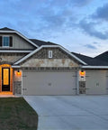 House with Magnetic Decorative Garage Door Hardware Set with 4 Faux Hinges and 2 Handles in Black Finish at dusk