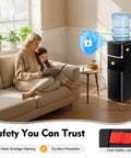 Top Loading Water Cooler With Three Temperature Options Hot Cold Warm For Three Or Five Gallon Bottles Stainless Steel Liner 75W Cooling And 550W Heating Child Safety Lock Black Finish displayed in a living room
