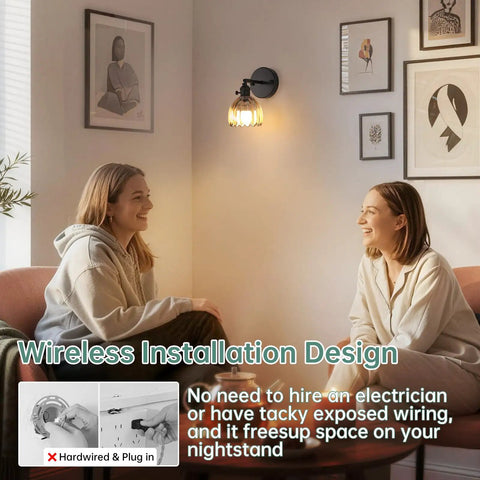 Vintage Battery Operated Wall Sconce With Amber Tulip Glass Lampshade illuminating a living room with two people seated on a couch.