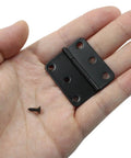 Killer 24 Pack Of 1.5 Inch Black Butt Hinges For Doors And Cabinets Hella Durable Steel Hardware with screw in hand.
