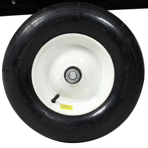 Close-up of tire on ATV Trailer Steel Dump Cart With 22 Cu Ft Capacity And 750 Lb Load, Heavy Duty Utility Trailer For Lawn And Garden