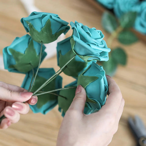 Close-up of hands crafting bouquet with All In One Flower Wire And Tape Kit For DIY Bouquets That Has You Covered Includes 26 Gauge And 18 Gauge Stem Wires 22 Gauge Paddle Wire Floral Tape And Green Floristry Supplies Cutter Included.