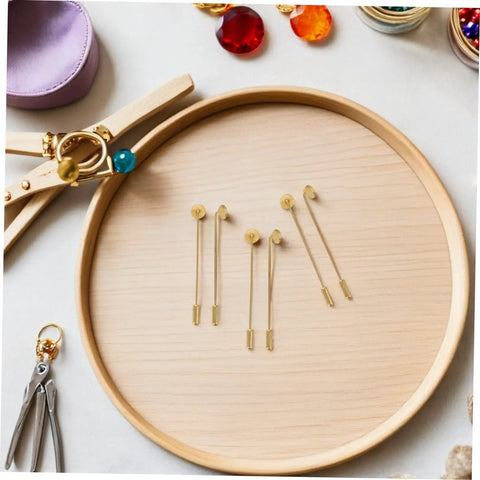 Bulk 50 Pack Copper Flat Round Tray Lapel Pins With Heavy Fabric Fastening And Raw Finish Metal Brooch Sticks For Industrial Crafts And Costume Accessories displayed on a wooden tray.
