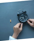 Person adjusting clock hands beside Grandfather Clock Weight Replacement Hook for DIY restoration projects with secure chain operation.