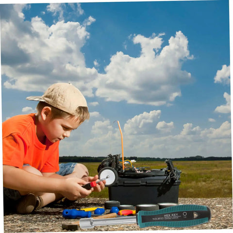 Child using tools next to a toolbox outdoors with Half Inch Hollow Shaft Nut Driver With Anti Slip Rubber Handle For Protruding Screw Removal And Precise Circuit Board Repair In Tight Workspaces Built Tough From 45 Steel For Long Lasting Service visible in foreground.