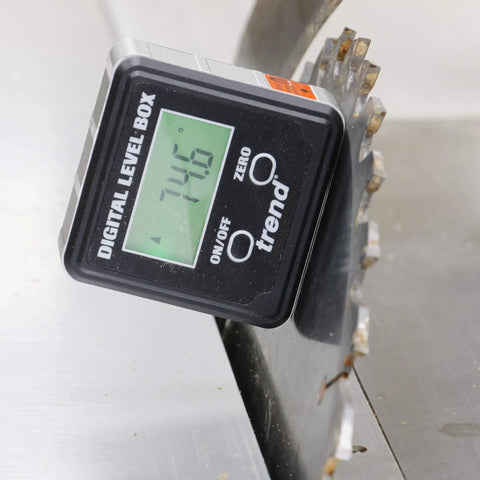 Digital Level Box And Angle Finder With Slick Magnetic Base And Backlit LCD Screen For Table Saw Miter Saw Blade Setup And Zero Sweat Bevel Cuts That Get Your Blades Dead On For Any Weekend Warrior Shop Build Black positioned on a saw blade.