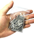 Hand holding a bag containing 5mm x 25mm Metal Dowel Pins 50 Pack For Wood Furniture And Shelves