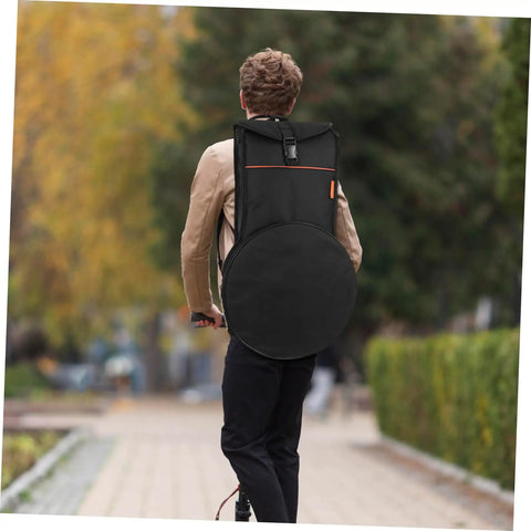 Person carrying a Road Ready Oxford Fabric Drum Storage Bag With Hella Tough Waterproof Seams on a bike path.