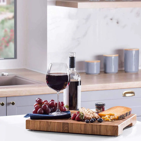 Heavy Duty Rubber Feet For Cutting Board With Stainless Screws 20 Pack on a kitchen countertop with wine and snacks.