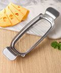 Heavy Duty Real Deal Butter And Cheese Slicer With Precision Stainless Steel Wires Ergonomic Grip next to sliced cheese.